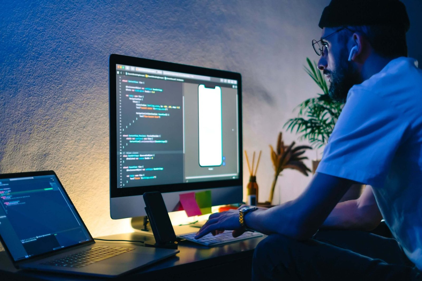 Young Man Mobile Developer Writes Program Code On 3FBNK5R Scaled 2
